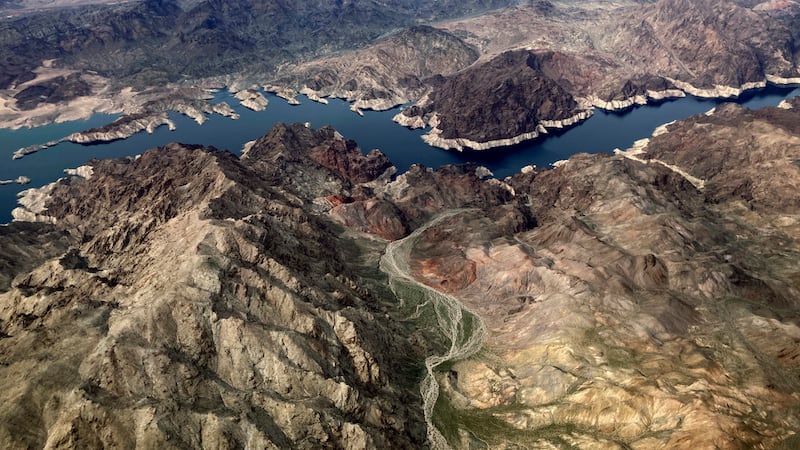 FILE - In this aerial photo, a bathtub ring of light minerals show the high water mark on the...