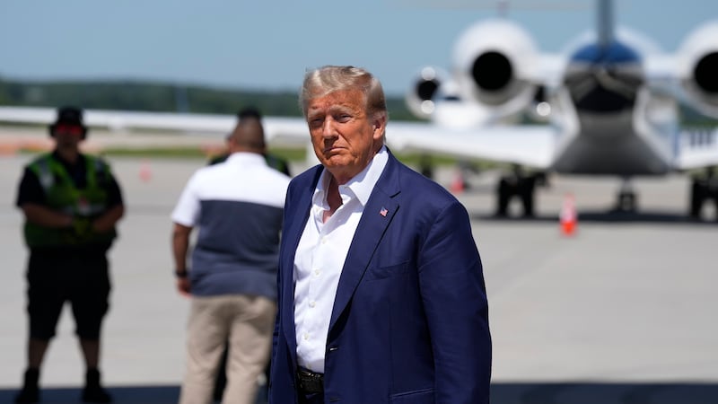 Republican presidential candidate former President Donald Trump walks to his vehicle after...