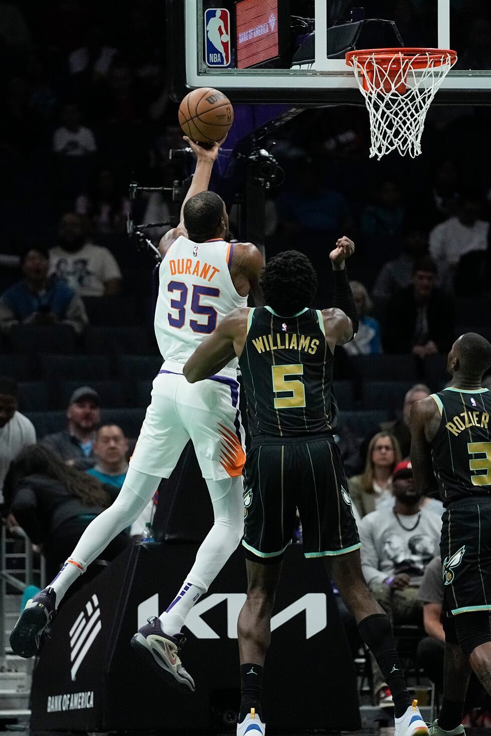Phoenix Suns forward Kevin Durant scores past Charlotte Hornets center Mark Williams during...