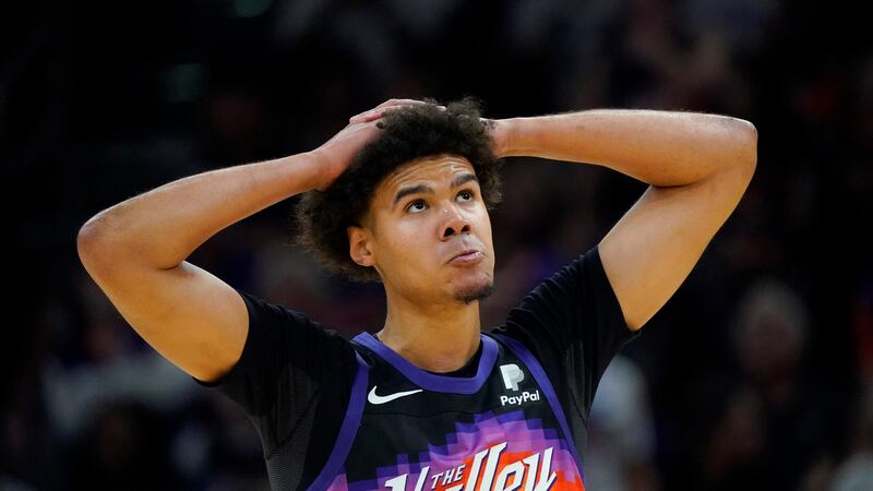 Phoenix Suns forward Cameron Johnson looks at the scoreboard during the first half of Game 7...