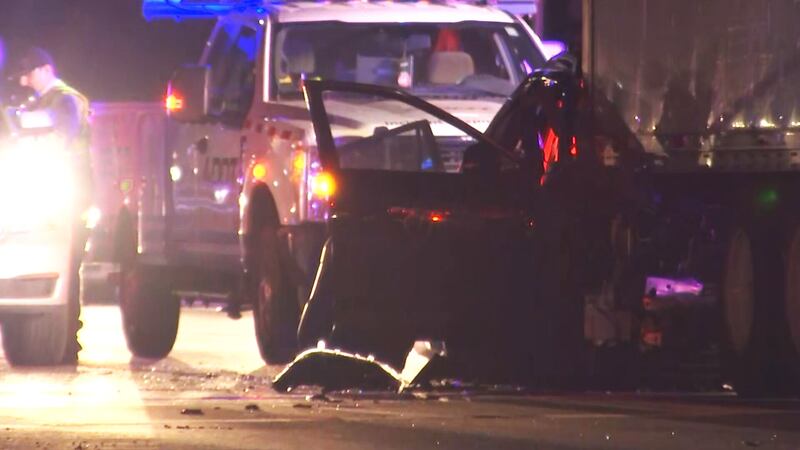 Video from the scene shows a mangled SUV underneath a semi. It's unclear how many people were...