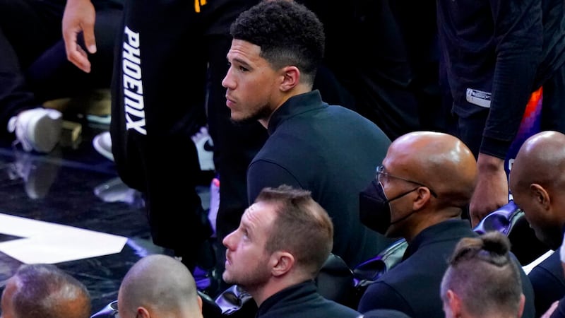 Phoenix Suns guard Devin Booker sits on the bench during the second half of Game 2 of an NBA...