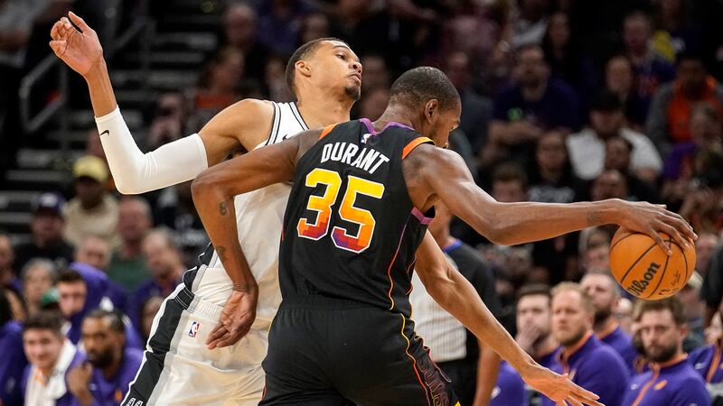 San Antonio Spurs' Victor Wembanyama (1) guards against Phoenix Suns' Kevin Durant (35) during...
