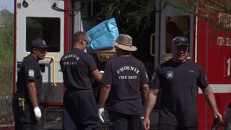 File photo showing Phoenix Fire medical personnel pushing a gurney into an ambulance at a...