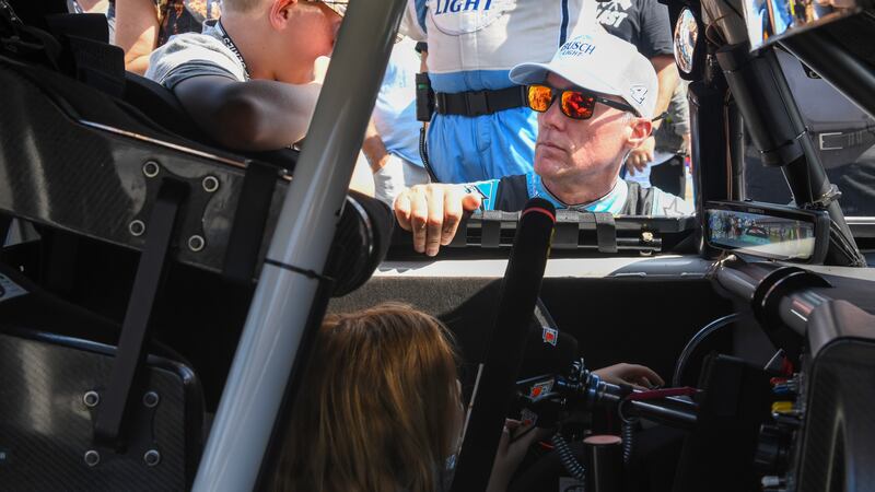 Driver Kevin Harvick visits with his children Keeland, left and Piper, before a NASCAR Cup...