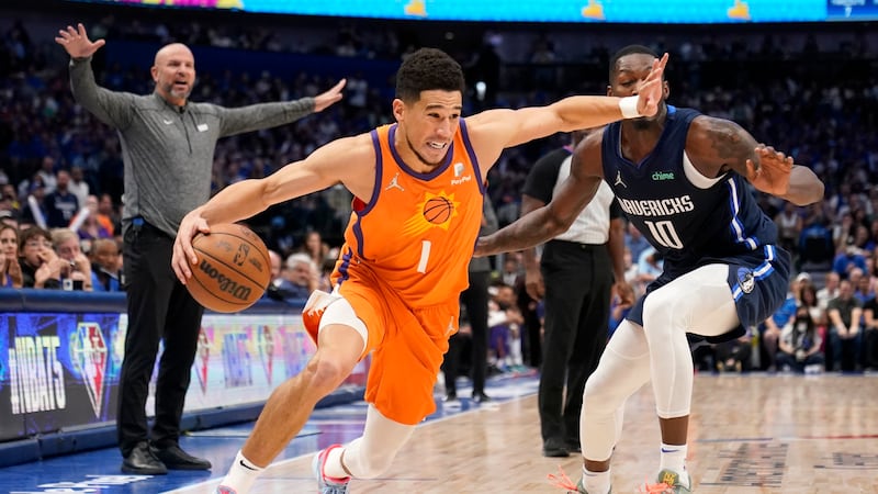 Phoenix Suns guard Devin Booker (1) drives to the basket past Dallas Mavericks forward Dorian...