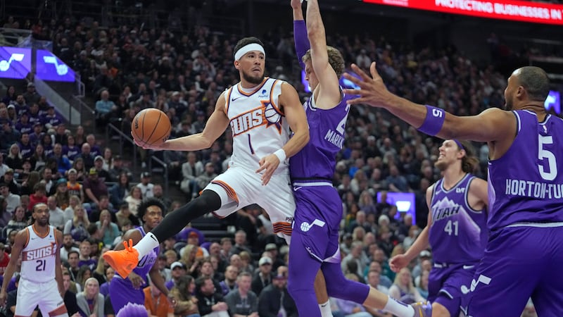 Phoenix Suns guard Devin Booker (1) passes the ball as Utah Jazz forward Lauri Markkanen...