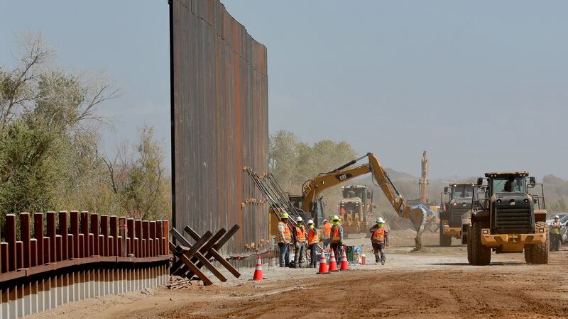 Contractors erect a section of border wall, replacing smaller fortifications, Tuesday, Sept....