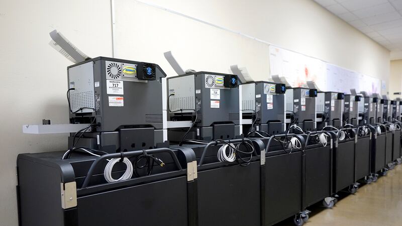 FILE - Affidavit printers are lined up at the Maricopa County Elections Department in Phoenix,...