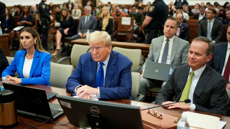 Former President Donald Trump, center, flanked by his defense attorneys, Alina Habba, left,...