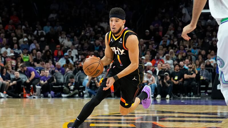 Phoenix Suns guard Devin Booker drives against the Minnesota Timberwolves during the first...