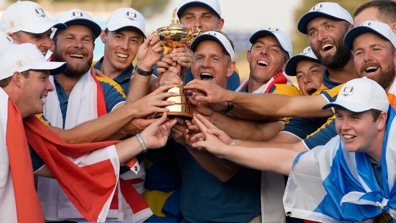 The Europe team led by Europe's Team Captain Luke Donald, at center, lift the Ryder Cup after...