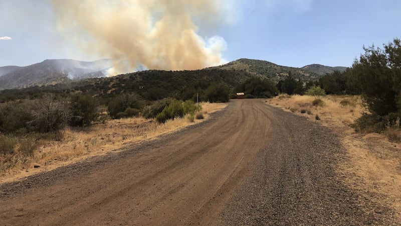 Smoke rises over a hillside on the northern portion of the Diamond Fire 0n July 26, 2023.