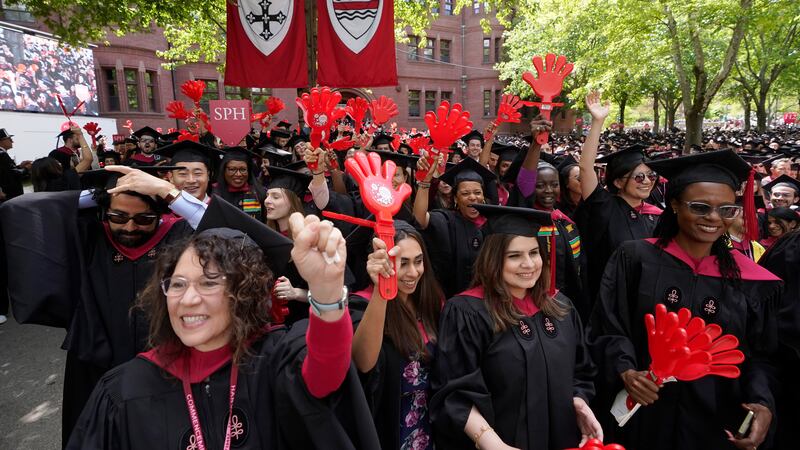 File - Graduating Harvard University students celebrate their degrees during commencement...