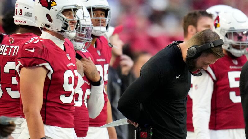 Arizona Cardinals head coach Kliff Kingsbury looks down during the second half of an NFL...